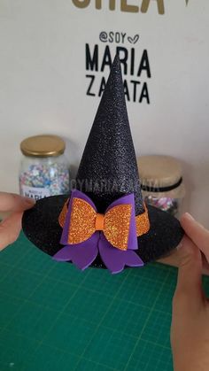 someone is making a witch hat out of paper