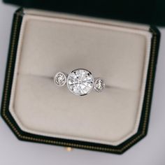 an engagement ring with three diamonds in it