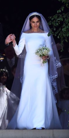 the bride is walking down the aisle in her wedding dress