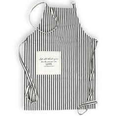 a black and white striped apron with an embroidered message on the front that says, be all you need is love