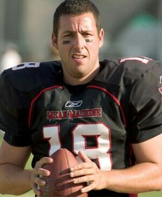 a man holding a football in his right hand and looking at the camera with an angry look on his face