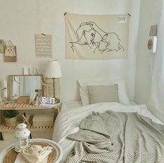 a bedroom with a bed, trays and pictures on the wall next to it