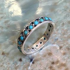 La la land~~~~~~~~~~~~~~~~This is a lovely multistone sterling silver eternity band with turquoise stones. if you wish to set different stones just let us know.(R2560)Construction & Dimensions:~~~~~~~~~~~~~~~~~~~~~~~sterling silver, turquoiseApproximate width: 4mmplease indicate your requested size in the order.About our jewelry~~~~~~~~~~~~~~ All of artisanfield jewelry collection is handmade.We  make the artisanfield designs from a goldfilled wire. *If, for any reason, you are not completel Silver Stackable Turquoise Ring For Anniversary, Stackable Sterling Silver Turquoise Ring For Wedding, Sterling Silver Stackable Turquoise Ring For Wedding, Wedding Stackable Turquoise Ring In Sterling Silver, Elegant Turquoise Ring With Round Band For Anniversary, Elegant Turquoise Ring For Anniversary With Round Band, Elegant Turquoise Ring For Anniversary, Turquoise Round Band Ring For Anniversary, Sterling Silver Stackable Rings With Multi-stone