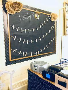 a blackboard with white writing on it next to speakers and other items in front of it