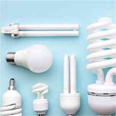 several different types of light bulbs on a blue background