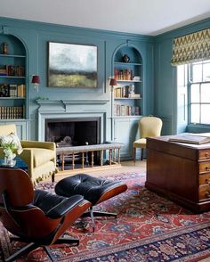 a living room filled with furniture and bookshelves next to a fire place in a fireplace