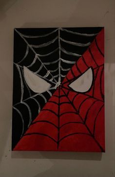 a spider - man painting is hanging on the wall