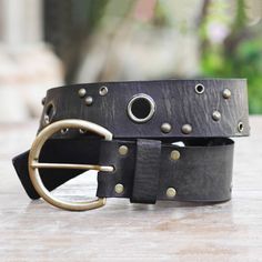 Balinese artisan Tomomi combines black leather and industrial iron accents in this simple statement-making belt. Embellished by fashionable iron studs the belt features an iron buckle and iron-rimmed eyelets for a comfortable adjustable closure. Black Leather Belt With Edgy Style, Adjustable Black Belt Buckles With Rivets, Adjustable Black Belts With Rivets, Antique Black Belt Buckles For Festivals, Black Leather Belts With Rivets, Black Leather Belt With Rivets, Adjustable Leather Belt Buckle With Metal Buckle, Black Punk Belt With Rivets, Adjustable Leather Belt With Metal Pin Buckle