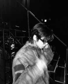 a young man walking up some stairs at night