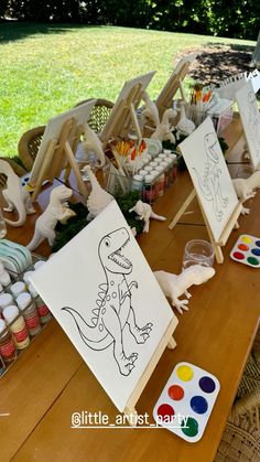 the table is set up with art supplies for kids to draw and paint on it