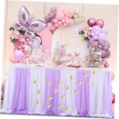 a table topped with lots of balloons and cake