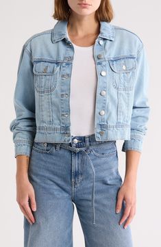 Add the perfect lightweight layer to your look with this timeless denim trucker jacket cut in a modern cropped silhouette. 20" length Front button closure Spread collar Button cuffs Chest button-flap patch pockets 100% cotton Machine wash, tumble dry Imported Model stats: 5'10", 32" bust, 25" waist, 36" hip. Casual Denim Vest With Snap Buttons For Spring, Casual Spring Denim Vest With Snap Buttons, Spring Casual Denim Vest With Snap Buttons, Spring Casual Denim Vest, Denim Cropped Jacket With Pockets, Cropped Light Wash Denim Jacket, Cropped Cotton Denim Jacket For Summer, Spring Cropped Denim Vest With Pockets, Summer Cropped Cotton Denim Jacket