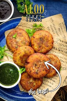 a blue plate topped with fried food next to dipping sauce