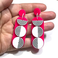 Channel your inner retro diva with these earrings inspired by the iconic Go-Go era. The lively colors and swinging design capture the spirit of fun. Created in hot pink and white acrylic, these earrings are 2 7/8" tall, the dangle is 2 1/4" long. They have stainless steel ear posts. Retro White Dangle Earrings, Pink Plastic Drop Earrings, Retro White Dangle Jewelry, Retro White Drop Earrings, Retro Pink Drop Earrings, Go Go Girl, Girl Earrings, Go Girl, Acrylic Jewellery