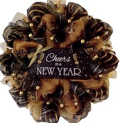 a black and gold wreath with cheers to a new year written on it's side