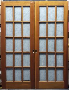 two wooden doors with frosted glass on them