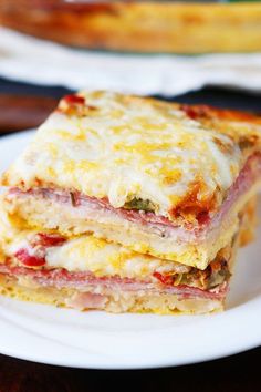 two slices of lasagna stacked on top of each other in front of a casserole dish