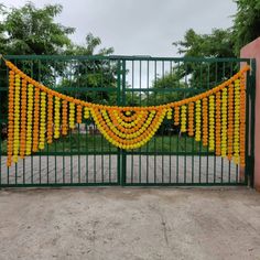 a gate decorated with oranges and string