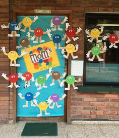 a door decorated with paper cutouts and stickers for men's day in front of a brick building