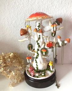 a figurine is shown with mushrooms and other things on it's base