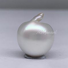 a white pearl ornament sitting on top of a table