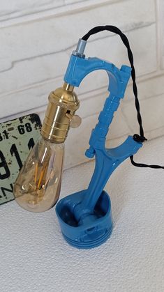 a blue light bulb sitting on top of a table next to a glass bottle filled with liquid