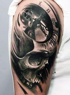 a man with a clock and skull tattoo on his arm