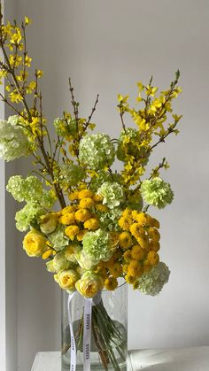 a vase filled with yellow and green flowers