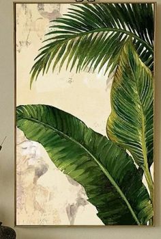 a painting of a green palm tree in front of a white wall with a brown frame