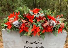 a sign that says southern edge style with poinsettis and pine cones