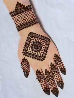 a hand with henna designs on it