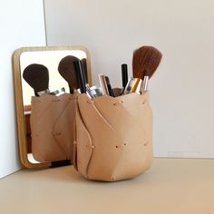 This brush pot is the perfect makeup organizer for vanity or home decor. The unique design and high-quality craftsmanship make it a standout piece as a makeup brush holder or cosmetic storage. The sleek and durable leather material ensures long-lasting use. Wether given as a gift or used for personal use, this handmade container is a must-have for anyone looking to add a stylish touch to their daily routine.  DIMENSIONS : Hight : 12cm/4"3/4 Width : 11cm/4,33" 100% HANDMADE : All processes (cutti Makeup Brush Holder, Tan Cowhide, Makeup Brush Holders, Makeup Organizer, Leather Gifts, Toiletry Storage, Cosmetic Storage, Brush Holder, Perfect Makeup