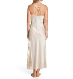 This full-length nightgown is an ethereal beauty, styled with wide, sheer side insets featuring scattered floral embroidery. Tall front neckline is slightly draped for graceful effect. Front fabric spaghetti straps run through goldtone connector ring at back, with lower straps that also run through ring and adjust with goldtone metal hardware. Sleeveless. Charmeuse and fine mesh panels are cut for a flattering silhouette. Mesh at sides has a scalloped edge at the hem. Shining, lustrous charmeuse Full-length Gown For Wedding Night, Elegant Sheer Slip Dress For Sleep, Elegant Sheer Night Dresses, Elegant Sheer Dresses For Night, Wedding Night Bias Cut Maxi Dress, Lace Gown With Sheer Back, Maxi Length Nightgown For Wedding Night, Full Length Gown With Lace Trim, Feminine Maxi Dress For Wedding Night