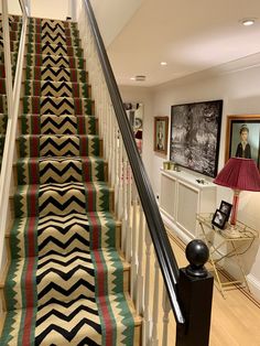 the stairs are decorated with multicolored rugs