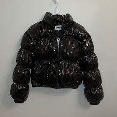 Never Worn, Tags Still On. Shiny Black Material. Size Small. In Excellent Condition. Black Puffer Jacket With Zipper For Spring, Black Puffer Jacket With Zipper Closure For Spring, Trendy Fitted Black Puffer Jacket, Fitted Black Puffer Jacket For Fall, Black Puffer Cropped Jacket For Fall, Trendy Black Puffer Jacket For Work, Chic Black Puffer Jacket For Cold Weather, Black Cropped Jacket With Padded Collar For Fall, Chic Black Puffer Jacket With Padded Collar