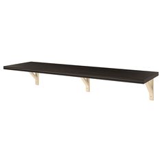 a black table with two wooden legs on it