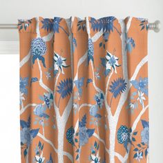 an orange curtain with blue and white flowers on it