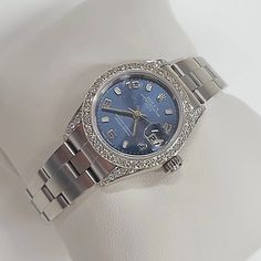 Women's Rolex 26mm DateJust Stainless Steel Watch, with Midnight Blue Dial, and Custom Diamond Bezel. Pre-Owned Brand: Rolex. Crystal: Sapphire. Gender: Women's. Bezel: Diamond Bezel. Dial Color: Midnight Blue. Movement: Self-Winding. Case Dimensions: 26mm. Metal Type: Stainless Steel. Bracelet / Strap: Oyster Band / Stainless Steel. Box / Certificate: Rolex Box / Certificate of Authenticity. Service Warranty: One (1) Year Limited Service Warranty. NOTE: This beautiful Rolex watch includes an af Blue Diamond Watch With Round Dial, Blue Diamond Watch With Diamond Hour Markers For Anniversary, Blue Diamond Watch For Anniversary, Blue Diamond Watch With Diamond Hour Markers, Blue Diamond Watches For Formal Occasions, Formal Blue Diamond Watches, Diamond Watch With Date Display For Gift, Silver Formal Watch Bands, Silver Watch Bands For Formal Occasions