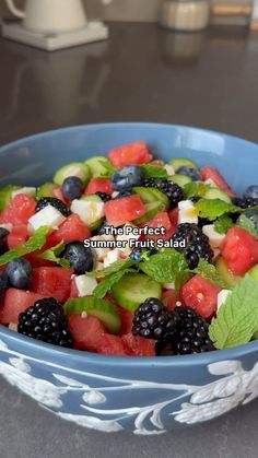 a blue bowl filled with mixed fruit salad