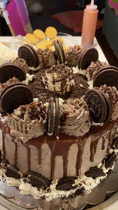 an oreo cookie cake with chocolate frosting and cookies on the top is ready to be eaten