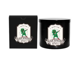 a black candle that is next to a box with the words irish springs on it