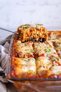 a glass casserole dish filled with lasagna and cheese