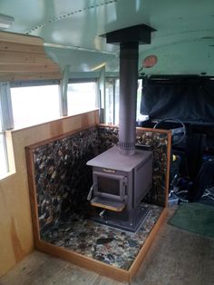 an image of a stove in the middle of a room that is being used as a camper