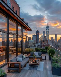 an outdoor living area with couches, tables and plants on the balcony overlooking the city