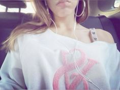 a woman sitting in the back seat of a car listening to music