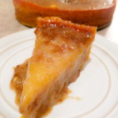 a piece of pie sitting on top of a white plate next to an orange slice