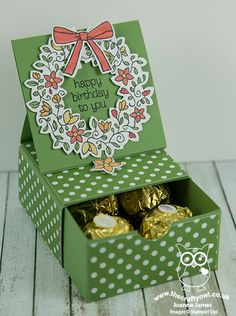 a green box with some chocolates in it