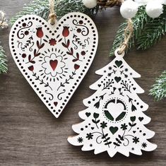 two wooden christmas ornaments hanging from a tree