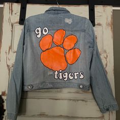 Never Worn Clemson Tigers Light Denim Jacket. Hand Painted With Acrylic Paint And Fabric Medium. Juniors Size Large. Smoke Free Home Painted Football Jean Jacket, Spring Denim Outerwear For College, Collegiate Cotton Outerwear For Spring, Fall Denim Jacket For College, College Denim Jacket For Fall, Spring Long Sleeve Denim Jacket For College, Casual Spring Denim Jacket For College, Spring Cotton Denim Jacket For College, Casual Fall Outerwear For Game Day