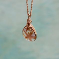 "̩̩͙✩ Handmade rose gold colored necklace with a starfish/amethyst crystal pendant ✩*̩̩͙*˚ Overview: ⋆ 1 x 0.75 inch rose gold colored pendant with amethyst crystals, reindeer moss & genuine starfish in resin-cast teardrop shaped frame ⋆ 18 inch rose gold colored chain with lobster clasp closure ⋆ Real amethyst crystals sourced from Brazil ⋆ February birthstone ⋆ Real starfish sourced from Florida, USA This pendant is made of tiny tumbled purple amethyst stones, a small sea star, and wisps of green moss sealed in a durable, clear resin window. The crystals partially extend beyond the resin on the front side and the back surface of the pendant is flat for ease of wear. The small star charm is about 0.25 inch long and can rest on either the front or back of the crystal pendant. The 18 inch/4 Dainty Rose Gold Pendant Crystal Necklaces, Rose Gold Teardrop Charm Necklaces As Gift, Rose Gold Teardrop Charm Necklace For Gift, Delicate Handmade Rose Gold Charm Necklaces, Delicate Handmade Rose Gold Charm Necklace, Dainty Rose Gold Teardrop Pendant Charm Necklace, Handmade Rose Gold Teardrop Necklace, Rose Gold Teardrop Drop Necklace Gift, Delicate Rose Gold Teardrop Necklace